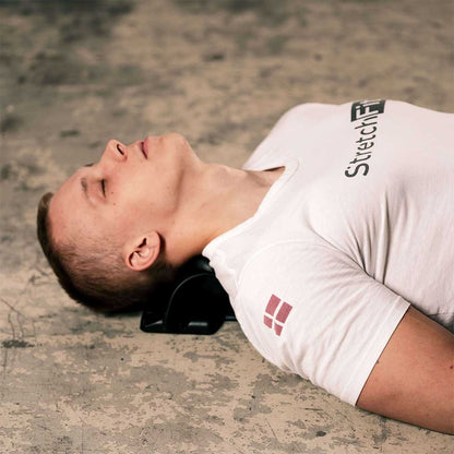 mand i hvid stretch fit skjorte liggende på nakkestraekker neckflex